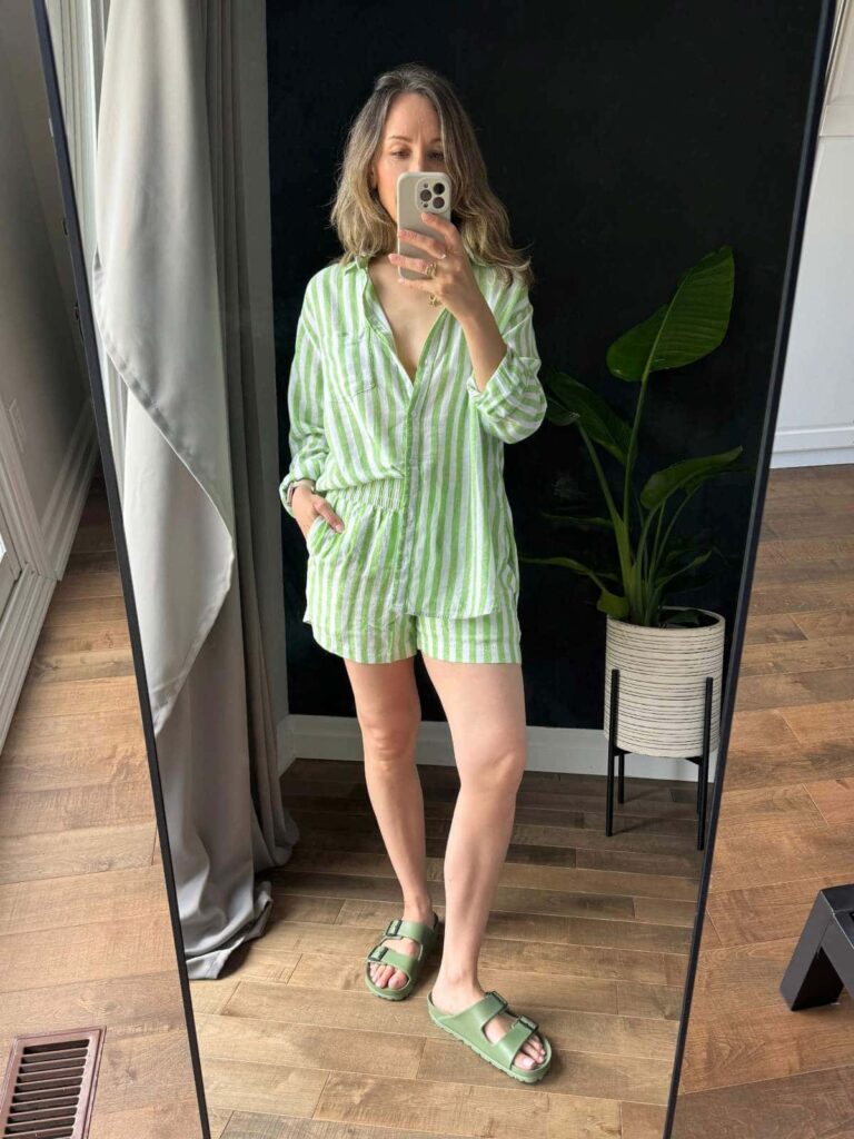 Woman posing in front of a mirror wearing striped linen-blend matching shorts set with shirt.