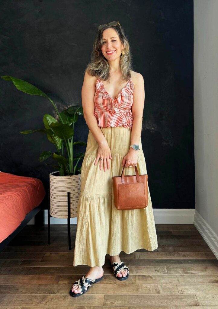 Woman posing wearing a linen camisole and maxi skirt for hot summer weather.