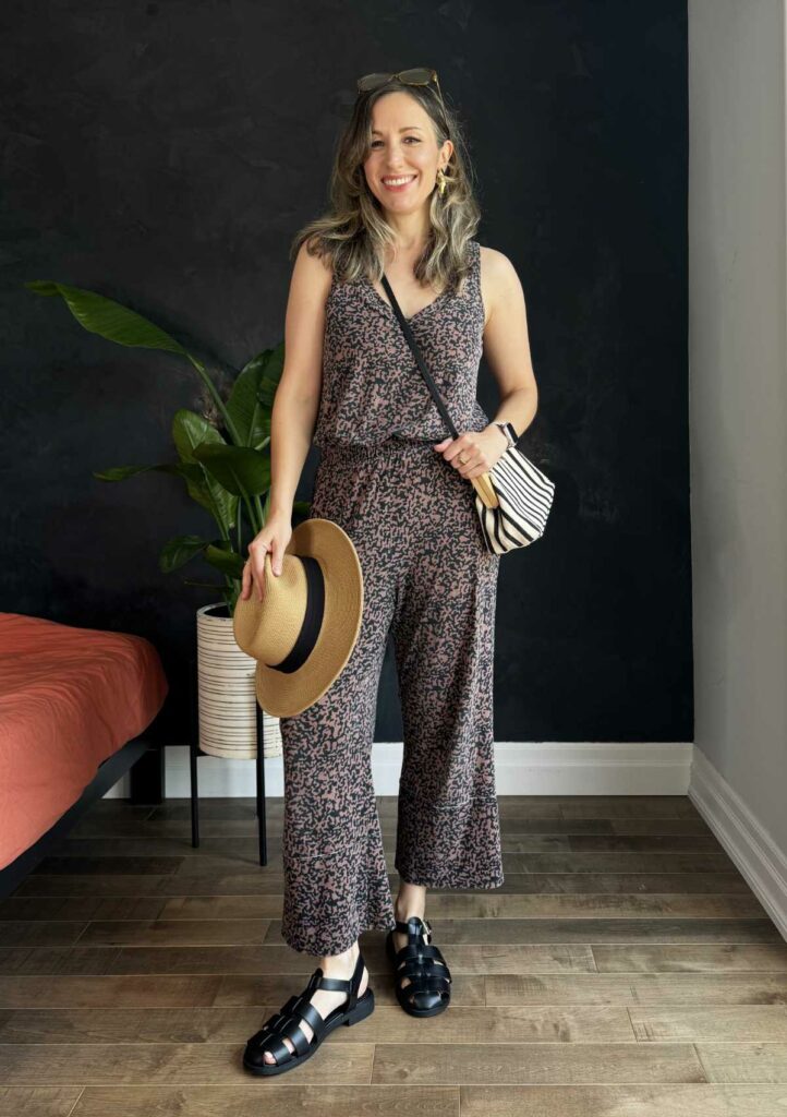 Woman posing wearing a printed wide-leg jumpsuit.