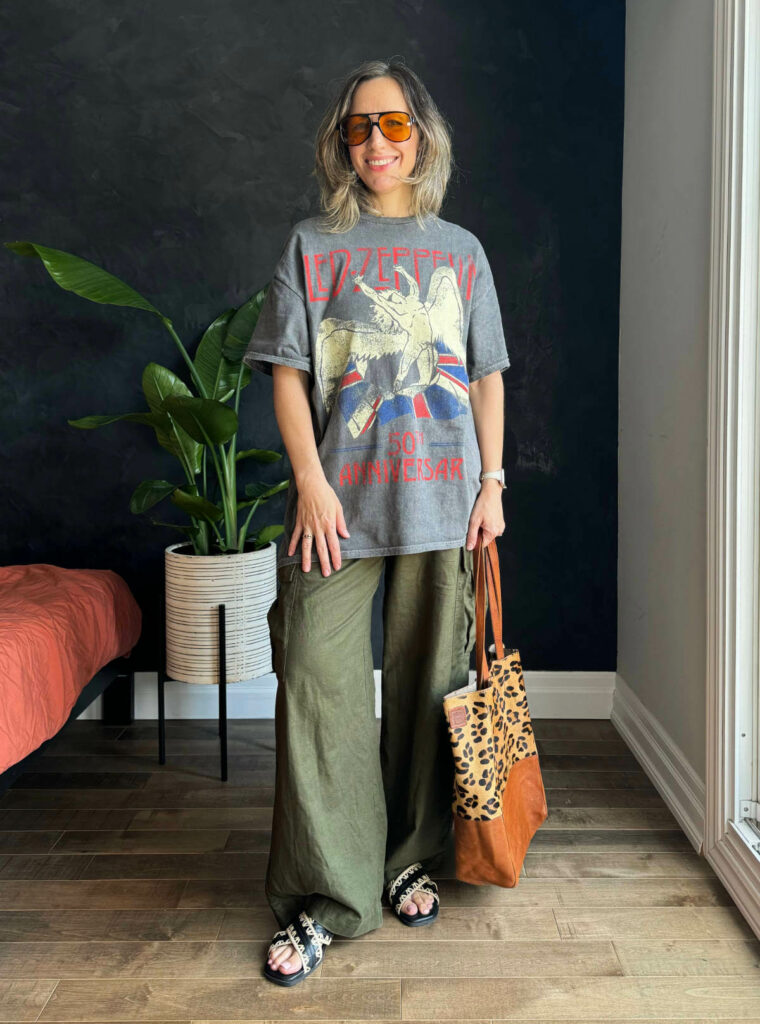 Woman posing wearing a graphic t-shirt outfit with linen cargo pants.