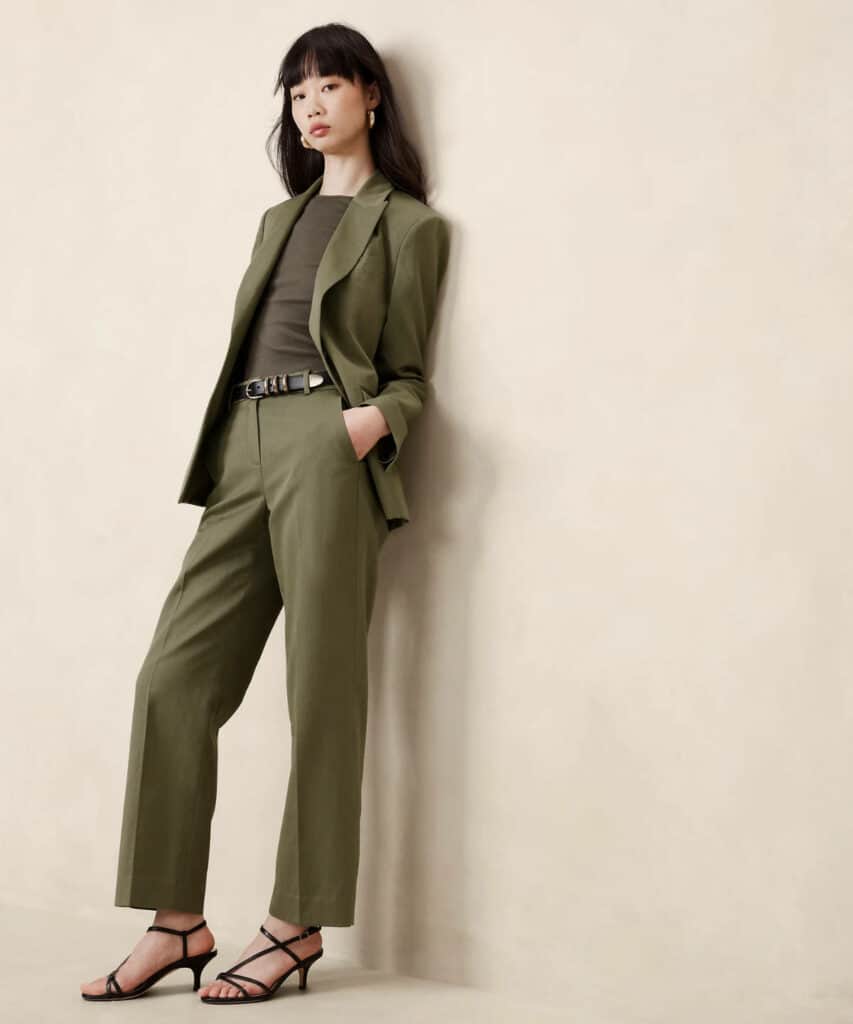 Woman posing wearing olive green pants with khaki green top.